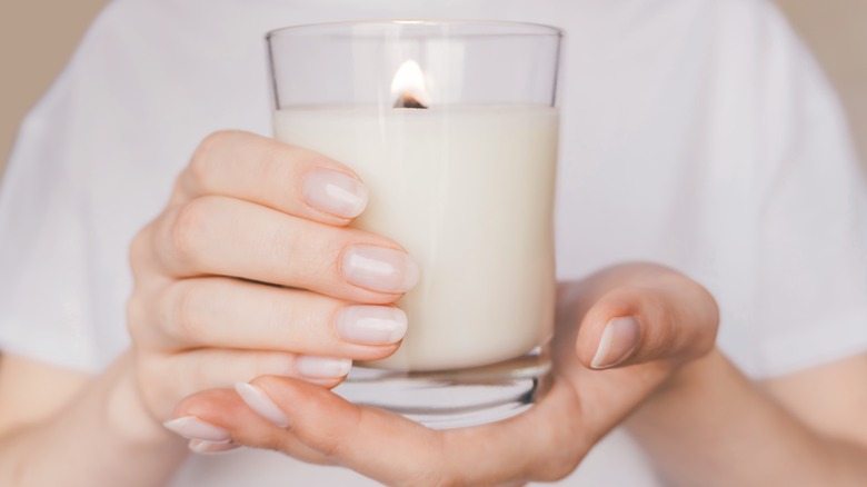 woman's hands holding a candle