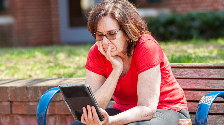 woman reading kindle in glasses