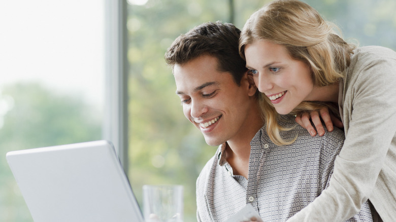 couple looking at  laptop