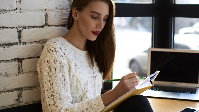 woman writing a poem