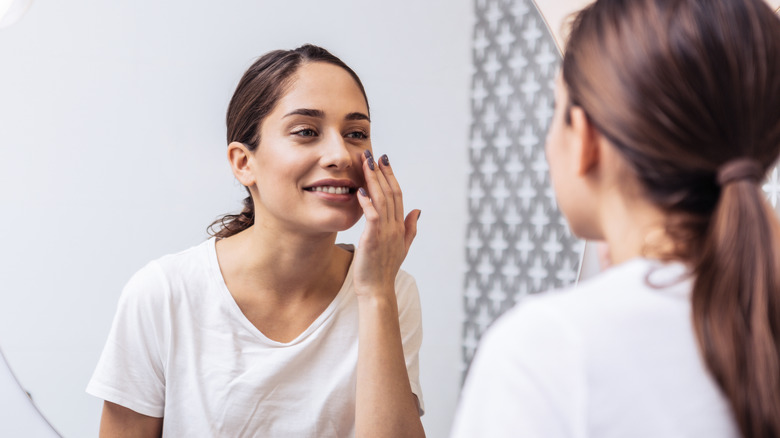 Woman putting on face cream