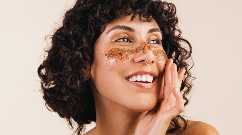 Woman with exfoliant on her face