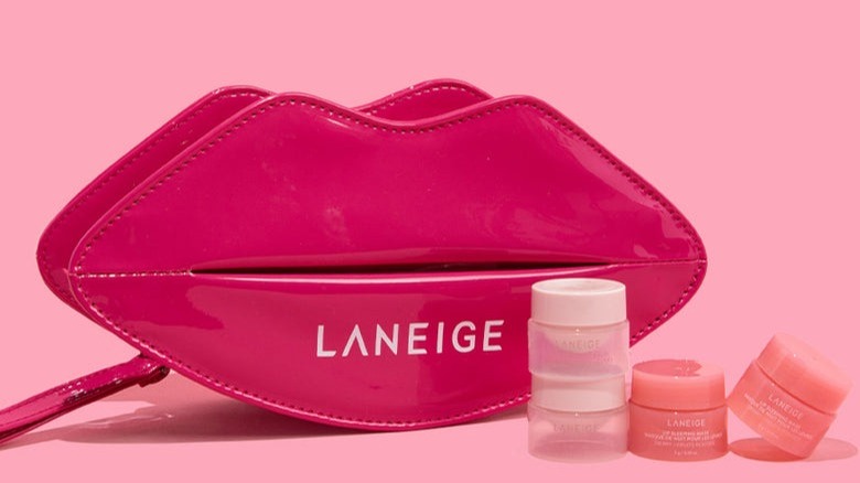 Laneige lip scrub and bag on pink background