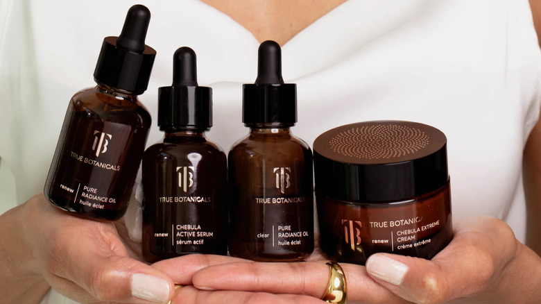 Woman holding True Botanicals skincare