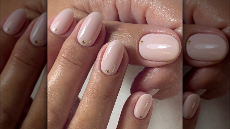 pink nails with gold dot nail art