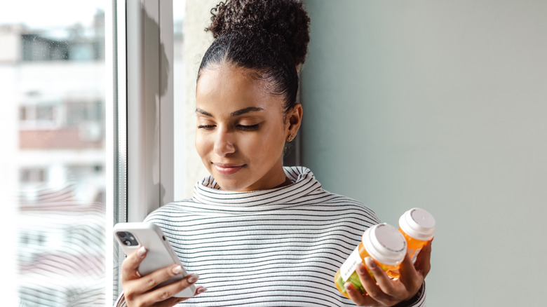 young woman with medication bottles