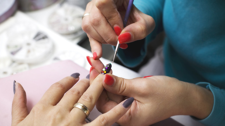 woman getting nail art