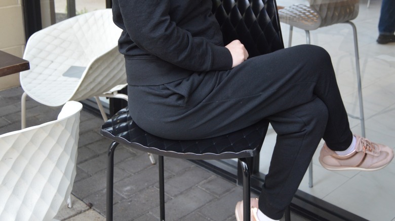 person sitting wearing black sweatsuit
