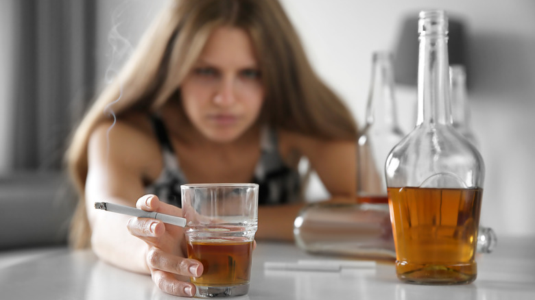 woman smoking and drinking