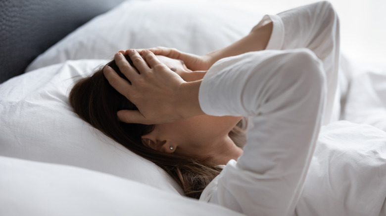 woman in bed feeling sad