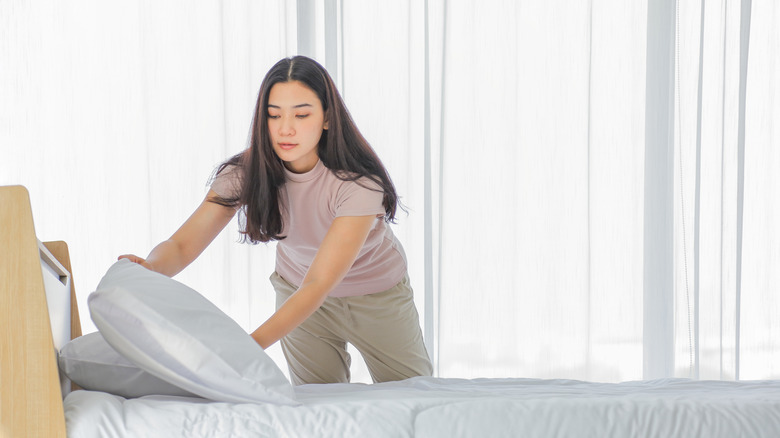 woman making the bed