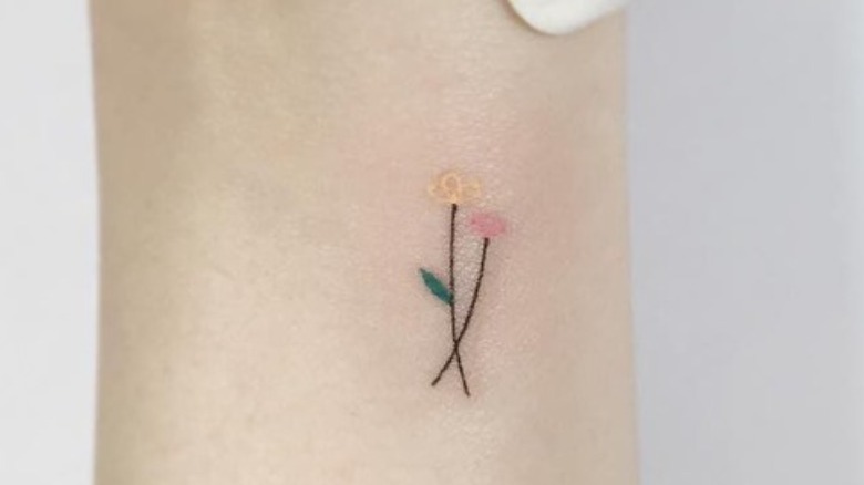 fine line flower tattoo with color