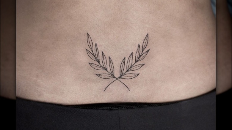 woman with lower back tattoo