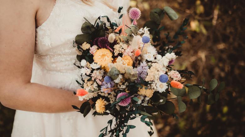 Bride holding a wildflower bouquet 