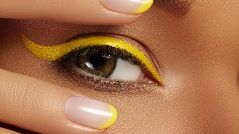 woman wearing yellow eyeliner
