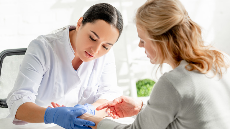 Dermatologist talking to a patient