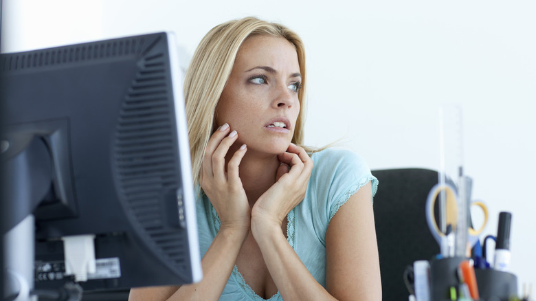 Anxious woman at computer 