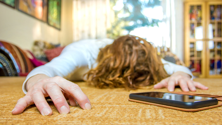 Person with head down phone nearby