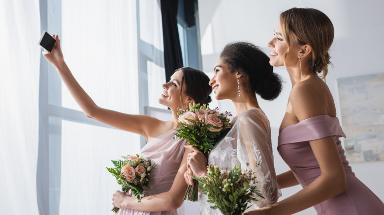 Bridesmaids in pink taking selfie