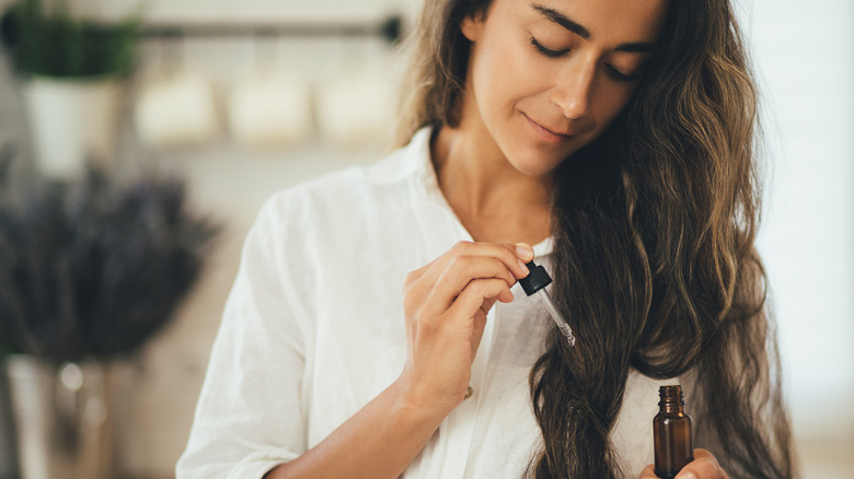 Woman applying hair treatment