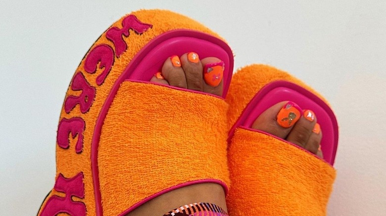 Toes with pink and orange pedicure