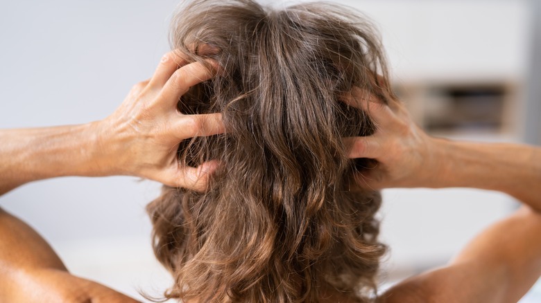 woman scratching hair 