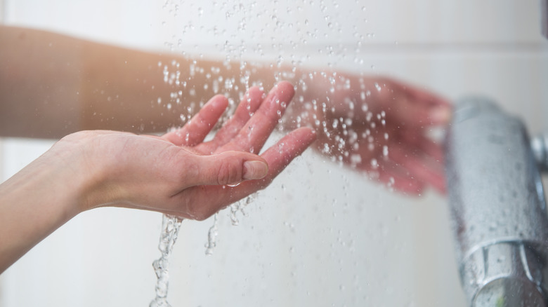 woman testing shower water