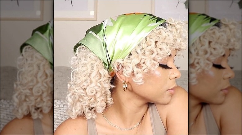 woman with short curly hair in bandana