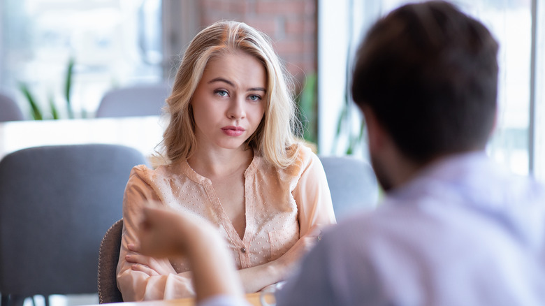 bored woman looking at man