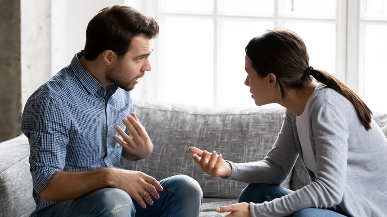 Couple arguing on couch