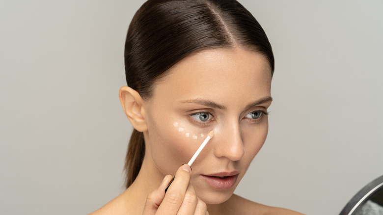 Woman putting on makeup