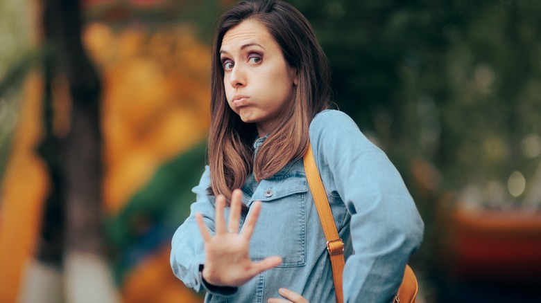 Woman holding hand up to say stop