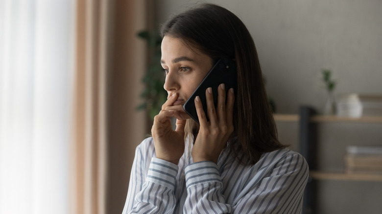 Woman on phone talking to therapist alone