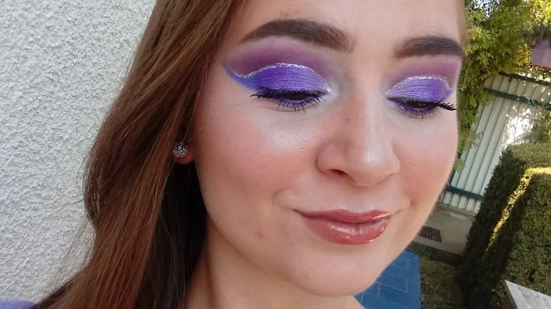 A woman wearing bright makeup