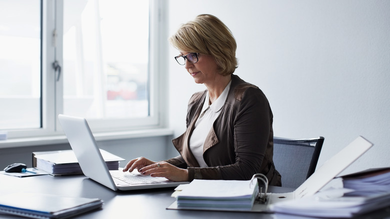 woman typing on a laptop at her desk