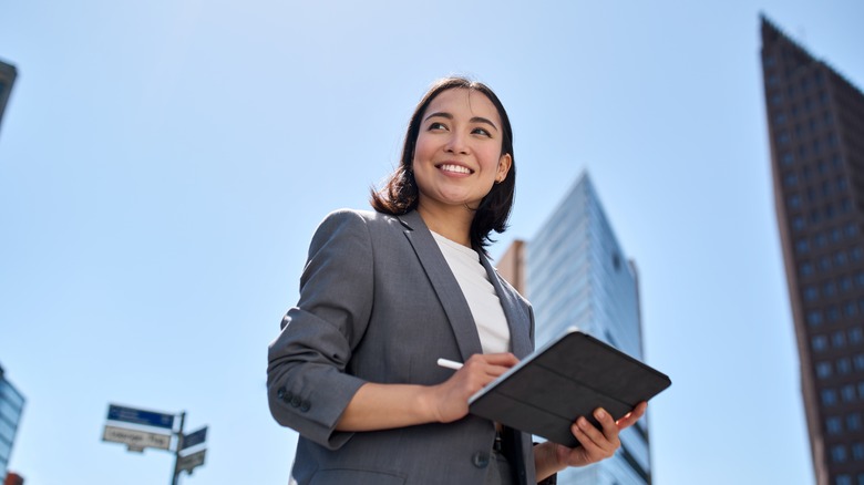 Confident woman smiling in city center 