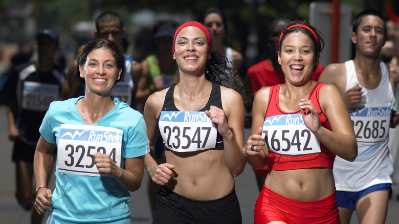 Women smiling as they finish a race together