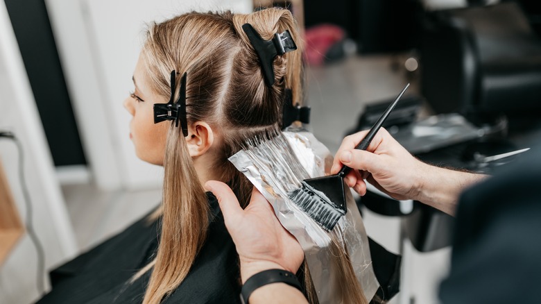 A woman getting her hair bleached