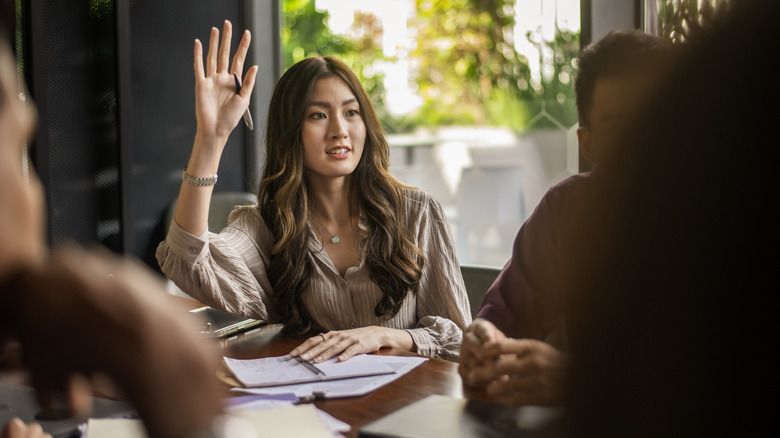 A woman raising her hand