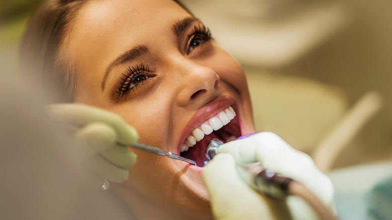 A woman getting her teeth checked