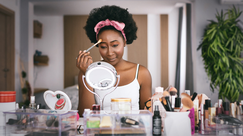 A woman applying makeup