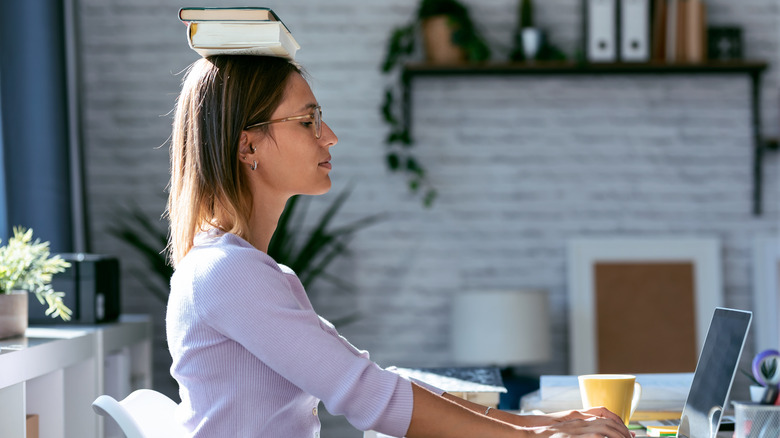 woman balancing book on head