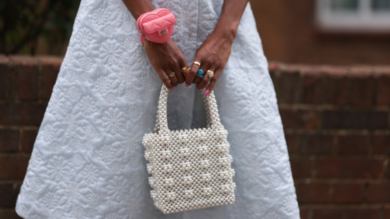 Woman carrying a pearl bag