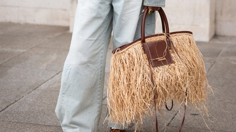 Woman carrying a raffia tote