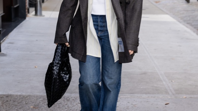 Margot Robbie carrying a woven bag