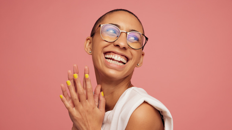 happy woman w/buzzcut and glasses