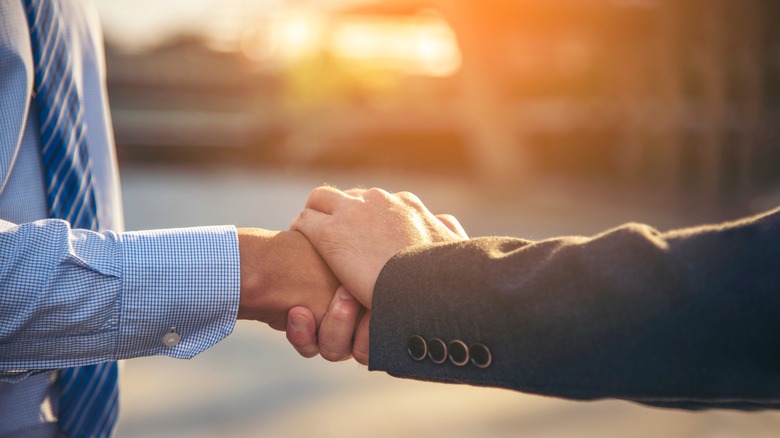 Two people shaking hands respectfully