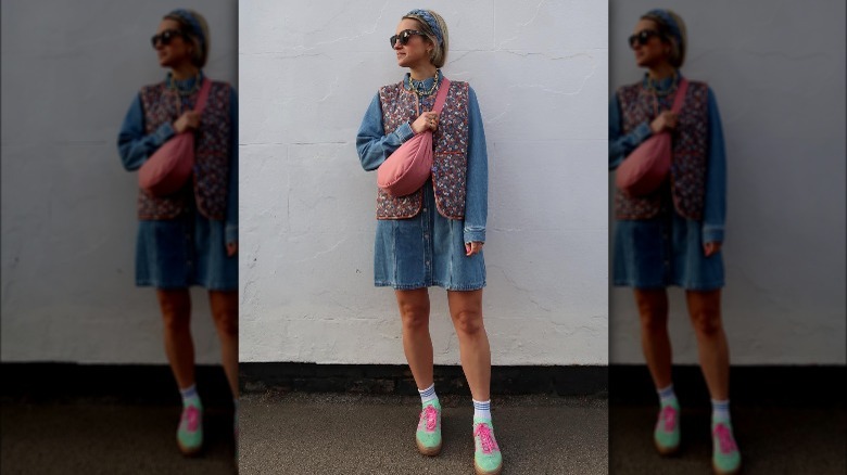 Woman wearing denim dress, vest