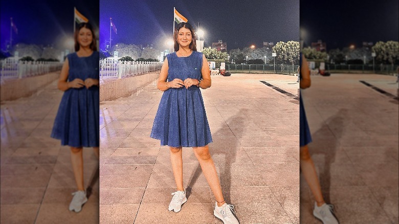 Woman in denim dress, sneakers