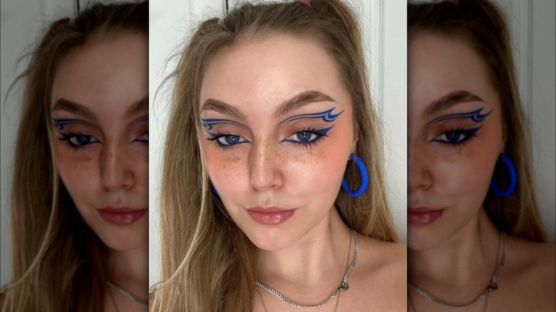 A woman with graphic blue eyeliner
